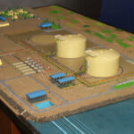 Color-coded industrial scale model showing factory equipment, piping and plant layout